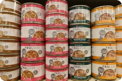 A row of canned wet cat food, including Truluxe cat food, available at Tilley's Pet Supplies, the best cat food store in Middleburg VA.