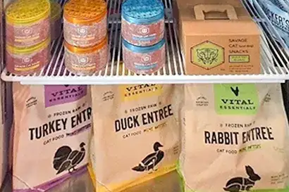 A fridge shelf holding the best fresh food for cats, including Steve's raw cat food, available at Tilley's Pet Supplies.
